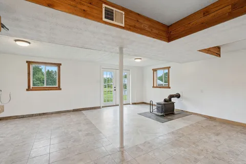 a view of a livingroom with furniture and a window