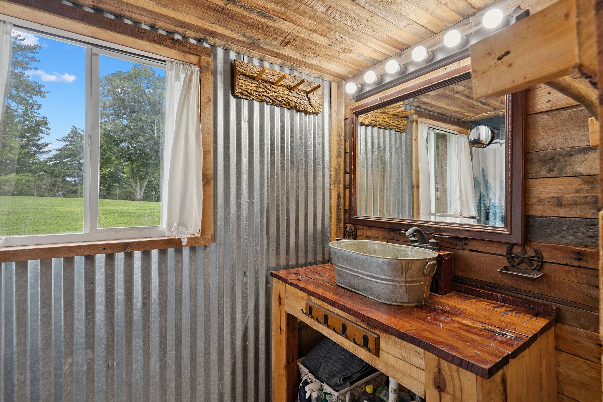 3037 Tunnel Road Westmoreland, TN 37186 - Photo 23 of 53 a bathroom with sink a mirror and a bathtub