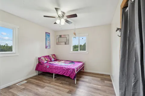 a bedroom with a bed and a chandelier