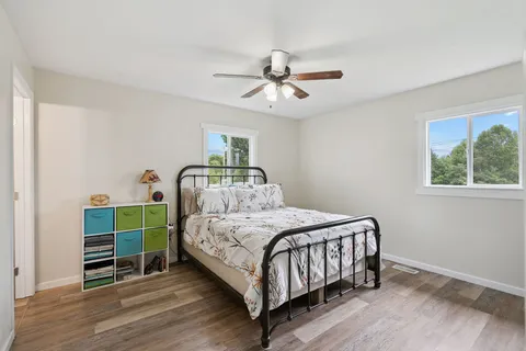 a bedroom with a large bed and a chandelier