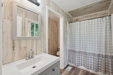 a view of a porch with furniture and wooden floor