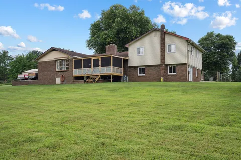 a front view of a house with yard and green space
