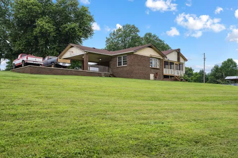 a front view of house with yard and green space