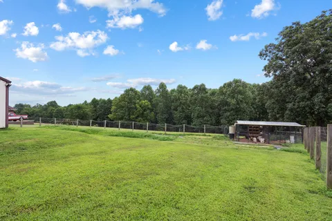 a view of a house with a backyard and a patio