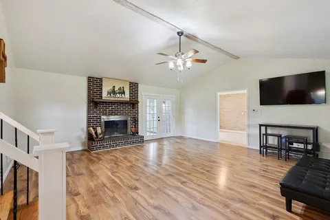 a living room with furniture fireplace and flat screen tv