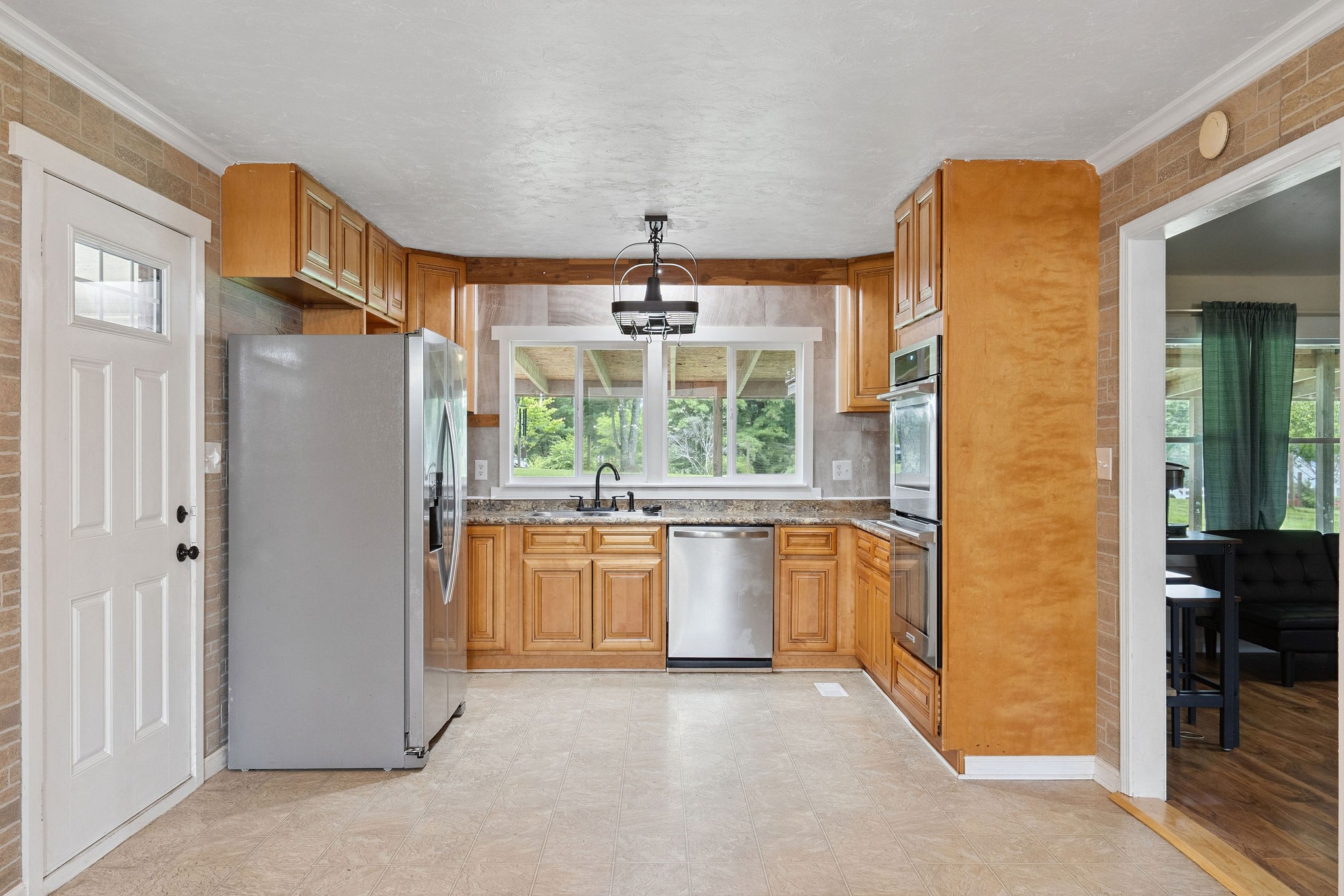 3037 Tunnel Road Westmoreland, TN 37186 - Photo 10 of 53 a kitchen with stainless steel appliances granite countertop a refrigerator and a sink