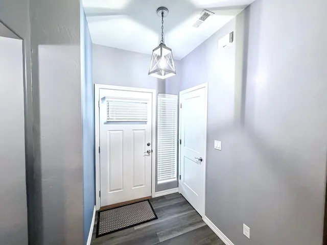 a very nice looking hallway with a chandelier