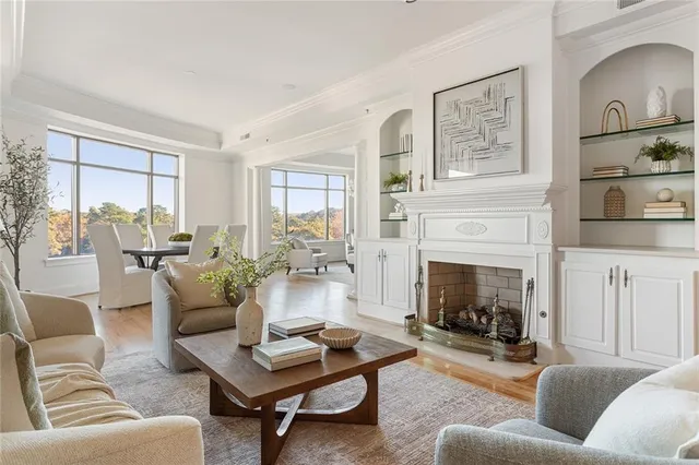 a living room with furniture fireplace and a window