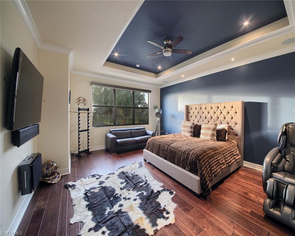 13693 Mandarin Circle Naples, FL 34109 - Photo 15 of 29 a bedroom with a bed couch and flat tv screen