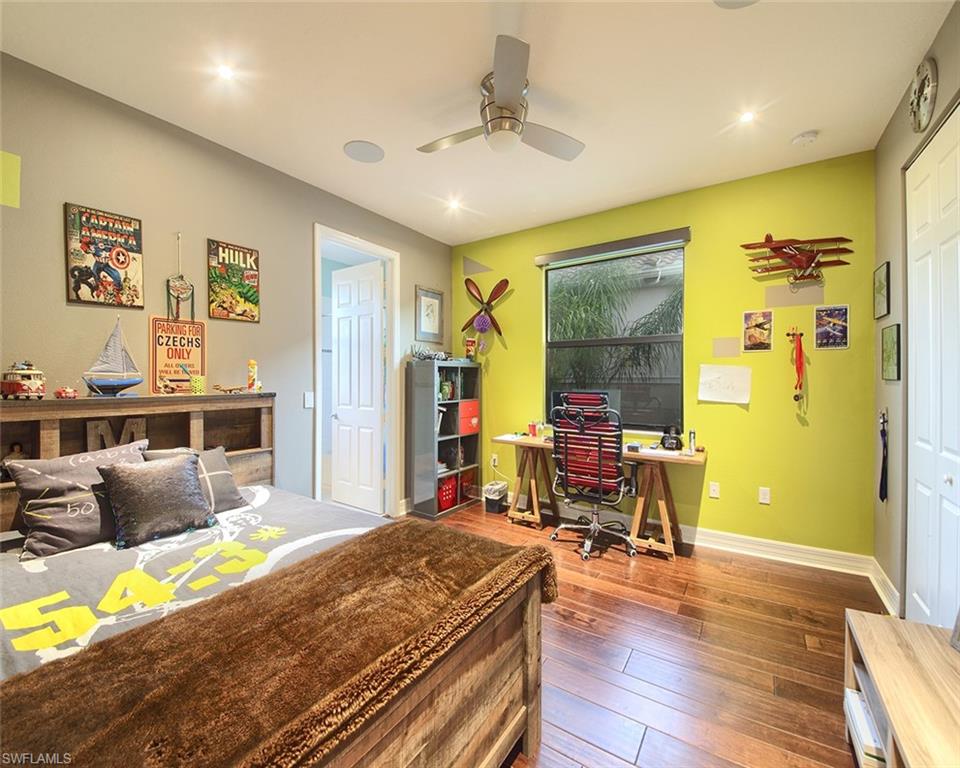 13693 Mandarin Circle Naples, FL 34109 - Photo 21 of 29 a bedroom with a bed and wooden floor