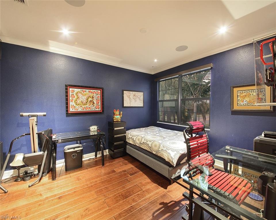 13693 Mandarin Circle Naples, FL 34109 - Photo 23 of 29 a bedroom with a bed and wooden floor