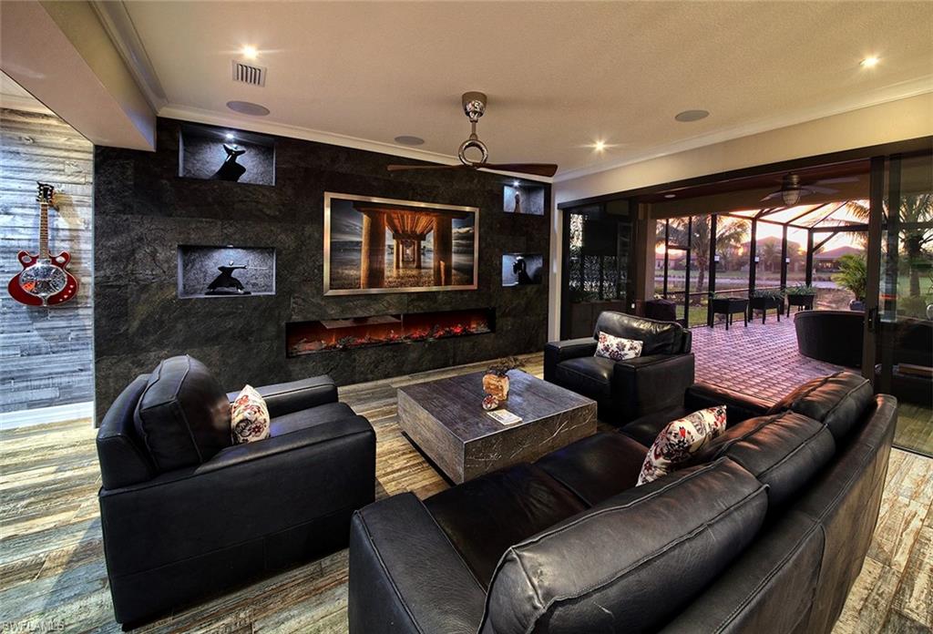 13693 Mandarin Circle Naples, FL 34109 - Photo 24 of 29 a living room with furniture and a flat screen tv