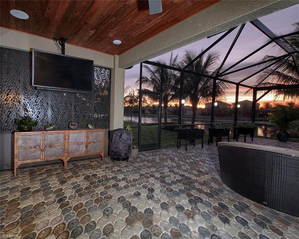 13693 Mandarin Circle Naples, FL 34109 - Photo 25 of 29 a view of a porch with furniture and a backyard