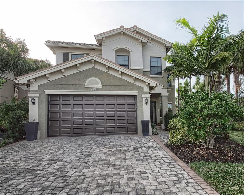 13693 Mandarin Circle Naples, FL 34109 - Photo 3 of 29 a front view of a house with a yard and garage