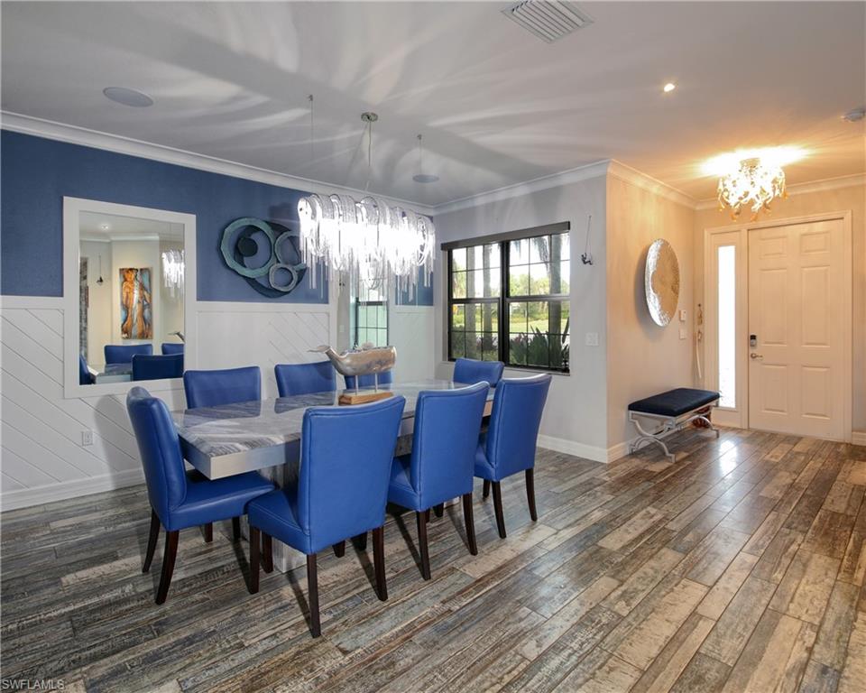 13693 Mandarin Circle Naples, FL 34109 - Photo 4 of 29 a view of a dining room with furniture window and wooden floor