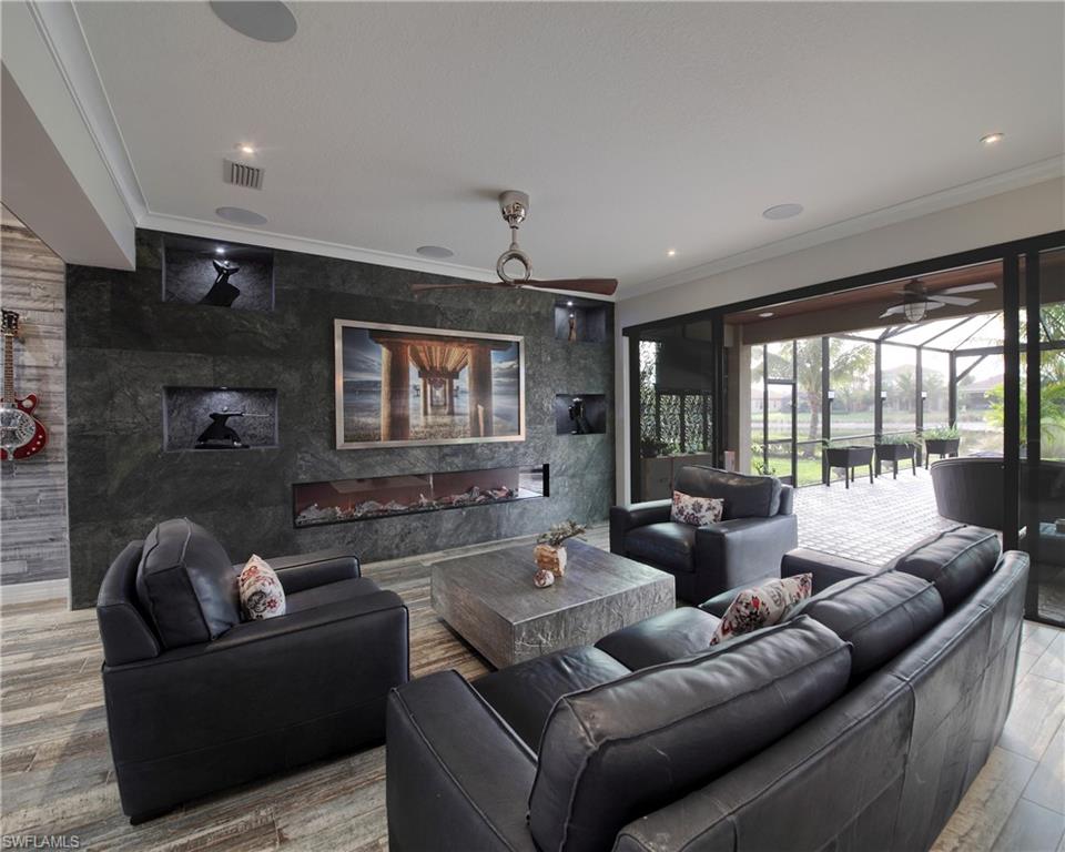 13693 Mandarin Circle Naples, FL 34109 - Photo 8 of 29 a living room with furniture and a large window