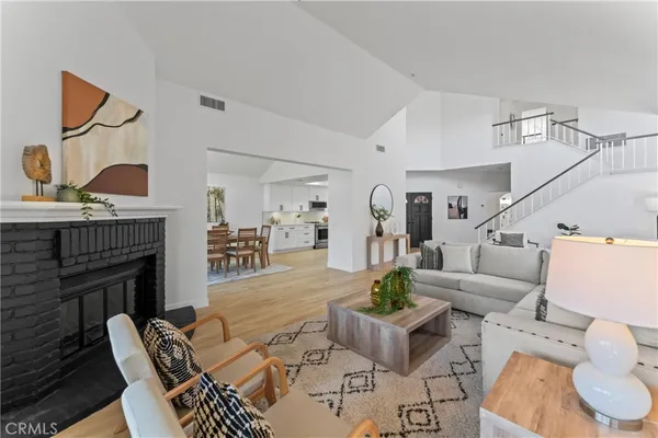 a living room with furniture a fireplace and a table