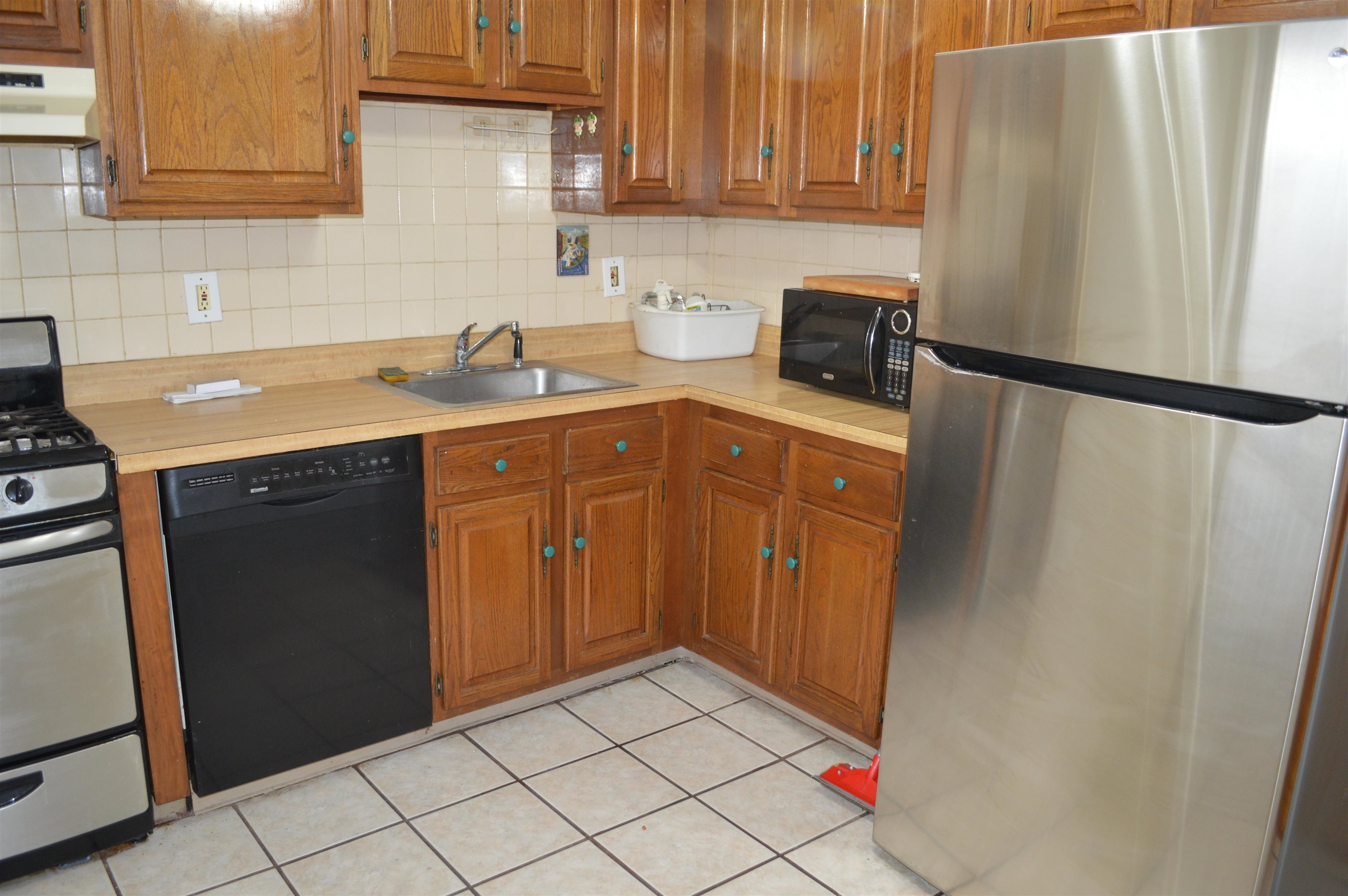 a kitchen with stainless steel appliances a refrigerator and a sink