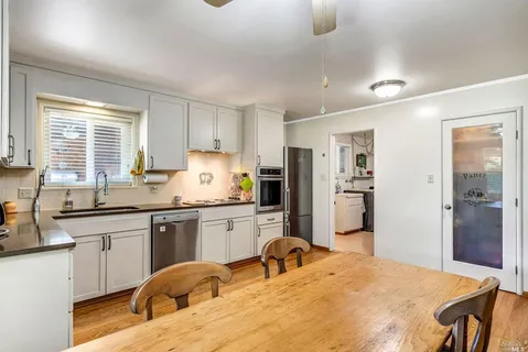 a kitchen with stainless steel appliances granite countertop a stove refrigerator sink and cabinets