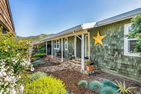 a view of a house with backyard and sitting area