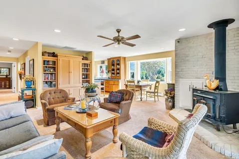 a living room with furniture a flat screen tv and a table