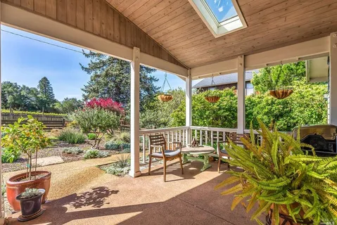 a view of a patio with a table chairs and a potted plant