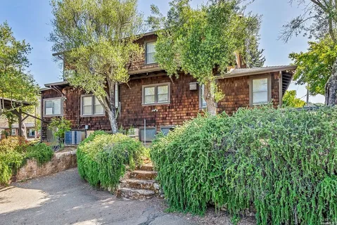 front view of a house with a tree