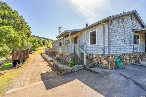 a view of a house with wooden fence