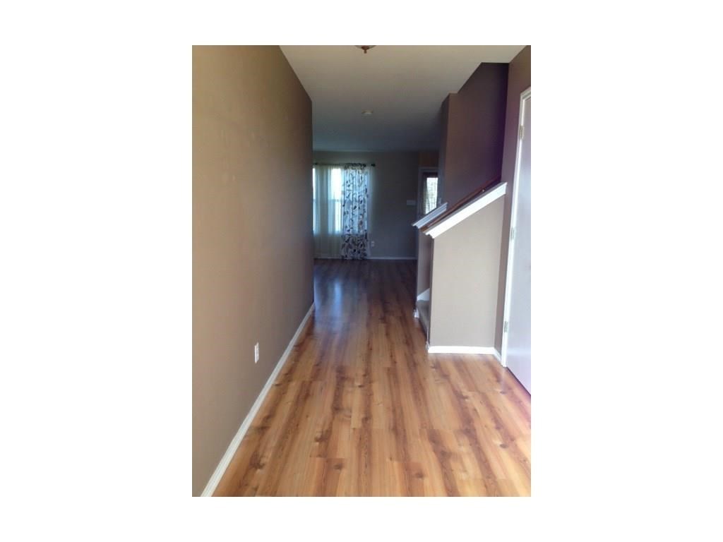 120 Rinehardt Street Hutto, TX 78634 - Photo 4 of 7 Corridor with baseboards and light wood finished floors