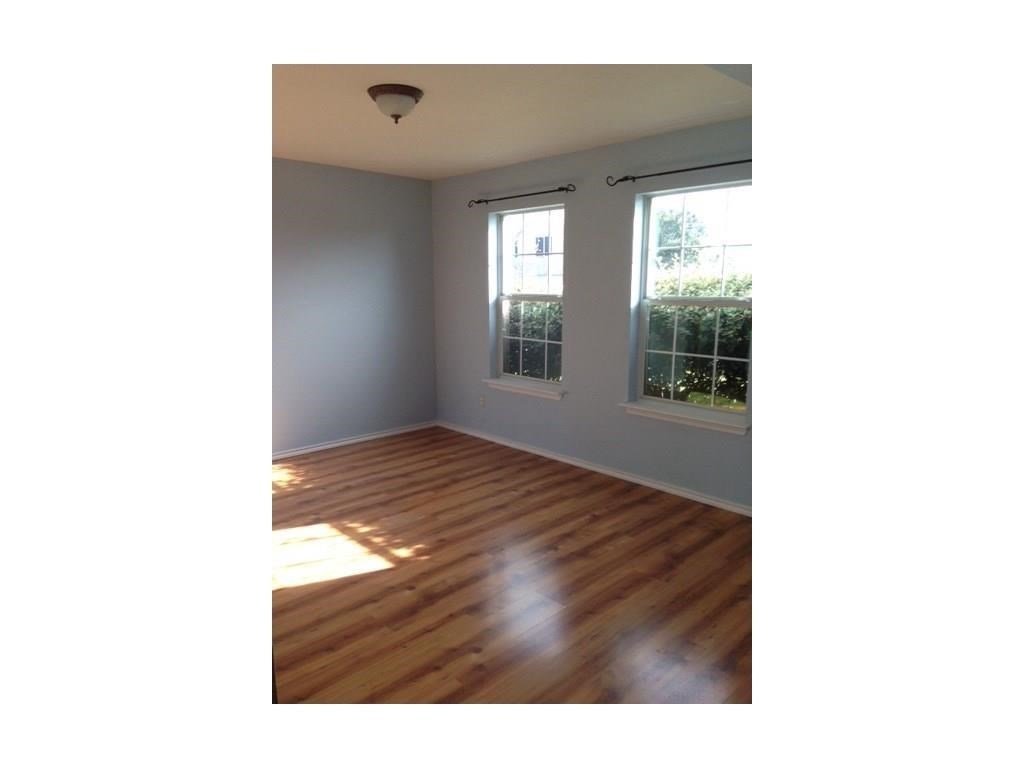 120 Rinehardt Street Hutto, TX 78634 - Photo 5 of 7 Empty room with wood finished floors and baseboards