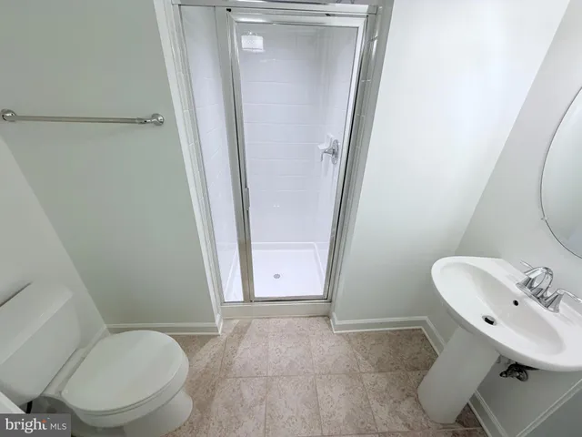 a bathroom with a toilet a sink and a mirror