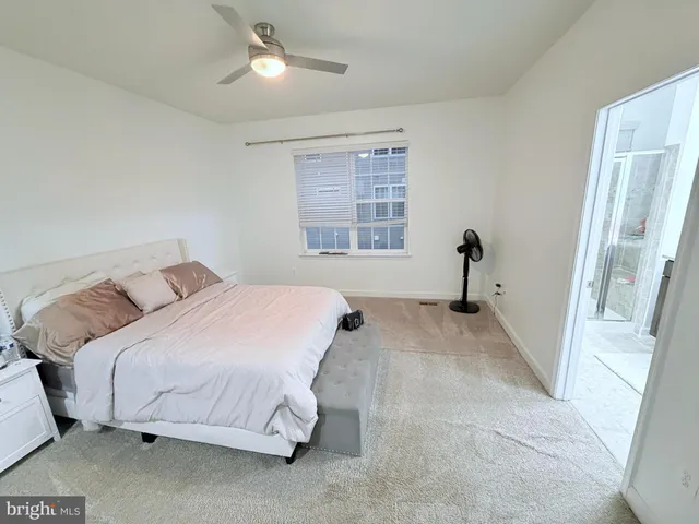 a bed room with a bed and a large window