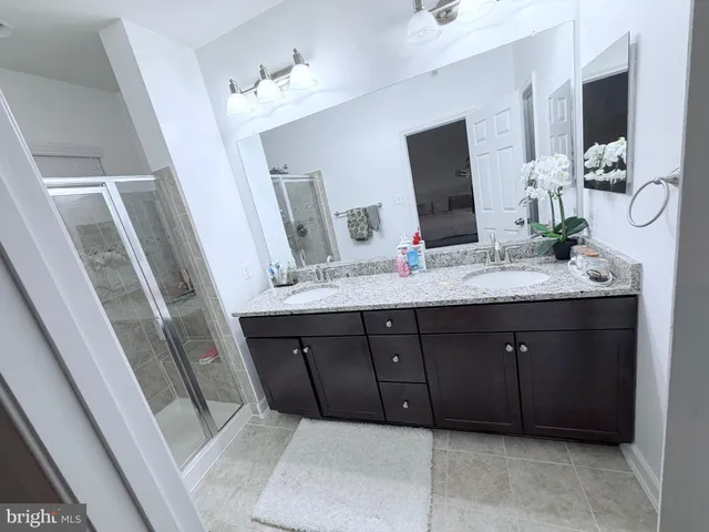 a bathroom with a double vanity sink and mirror