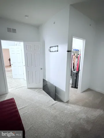 a view of hallway with furniture and a window