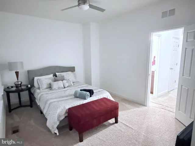 a bedroom with bed and a window