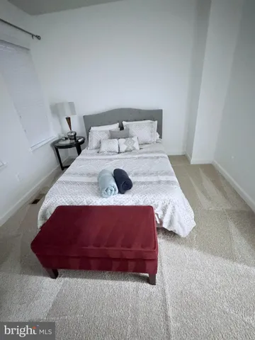 a bedroom with a bed and a night stand