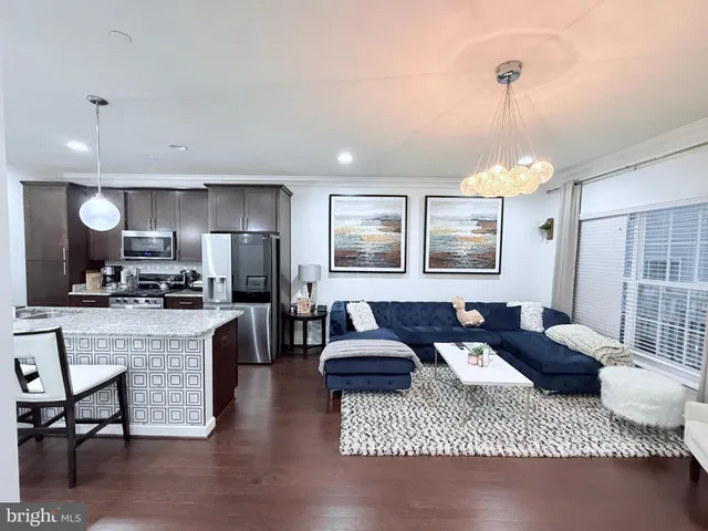 a living room with furniture rug and a table