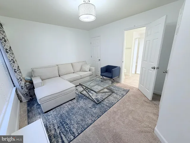 a living room with furniture and a rug