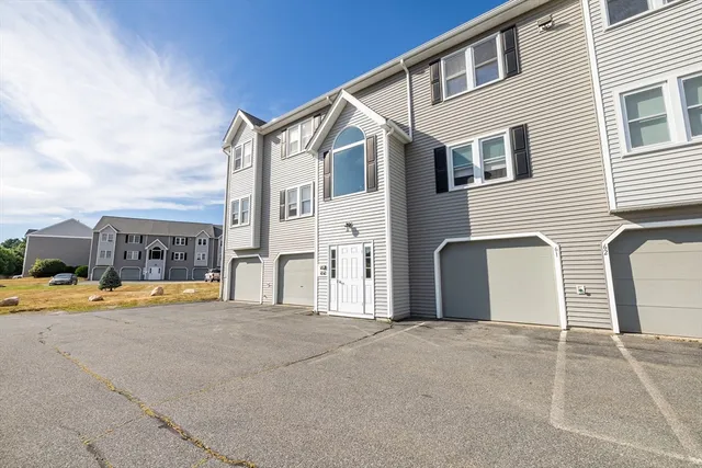 a view of a house with patio and a yard