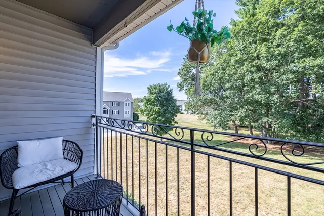 a view of a balcony with furniture