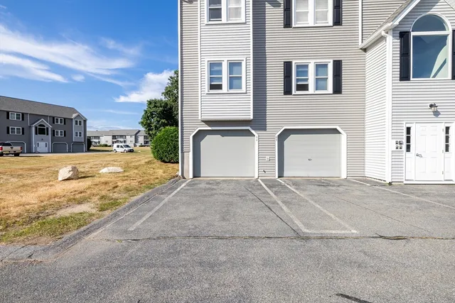 a view of a house with a yard and garage