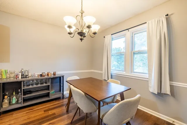 a view of a dining room with furniture wooden floor and chandelier