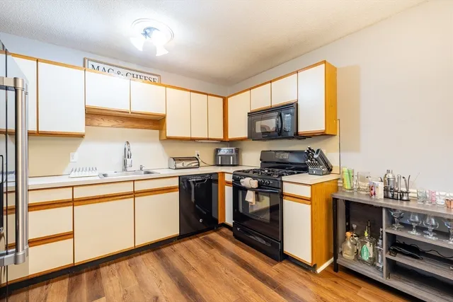 a kitchen with stainless steel appliances a stove sink and cabinets