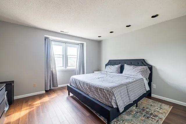 a bedroom with a bed and window