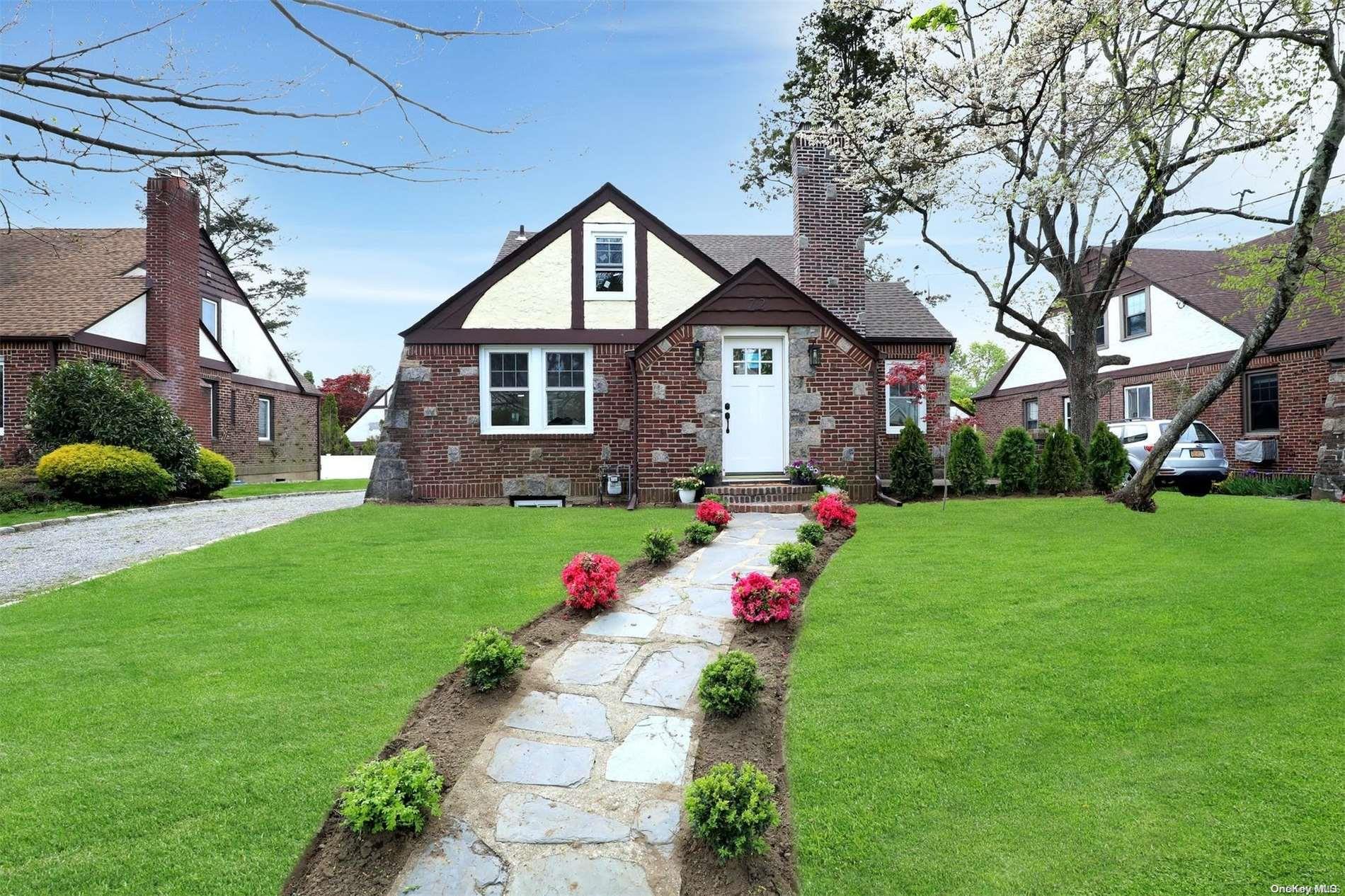 a front view of a house with garden