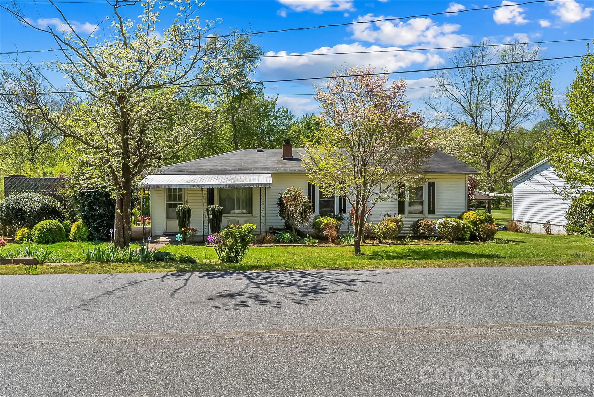 428 Melrose Street Southwest Lenoir, NC 28645 - Photo 1 of 34 a front view of a house with a yard and trees