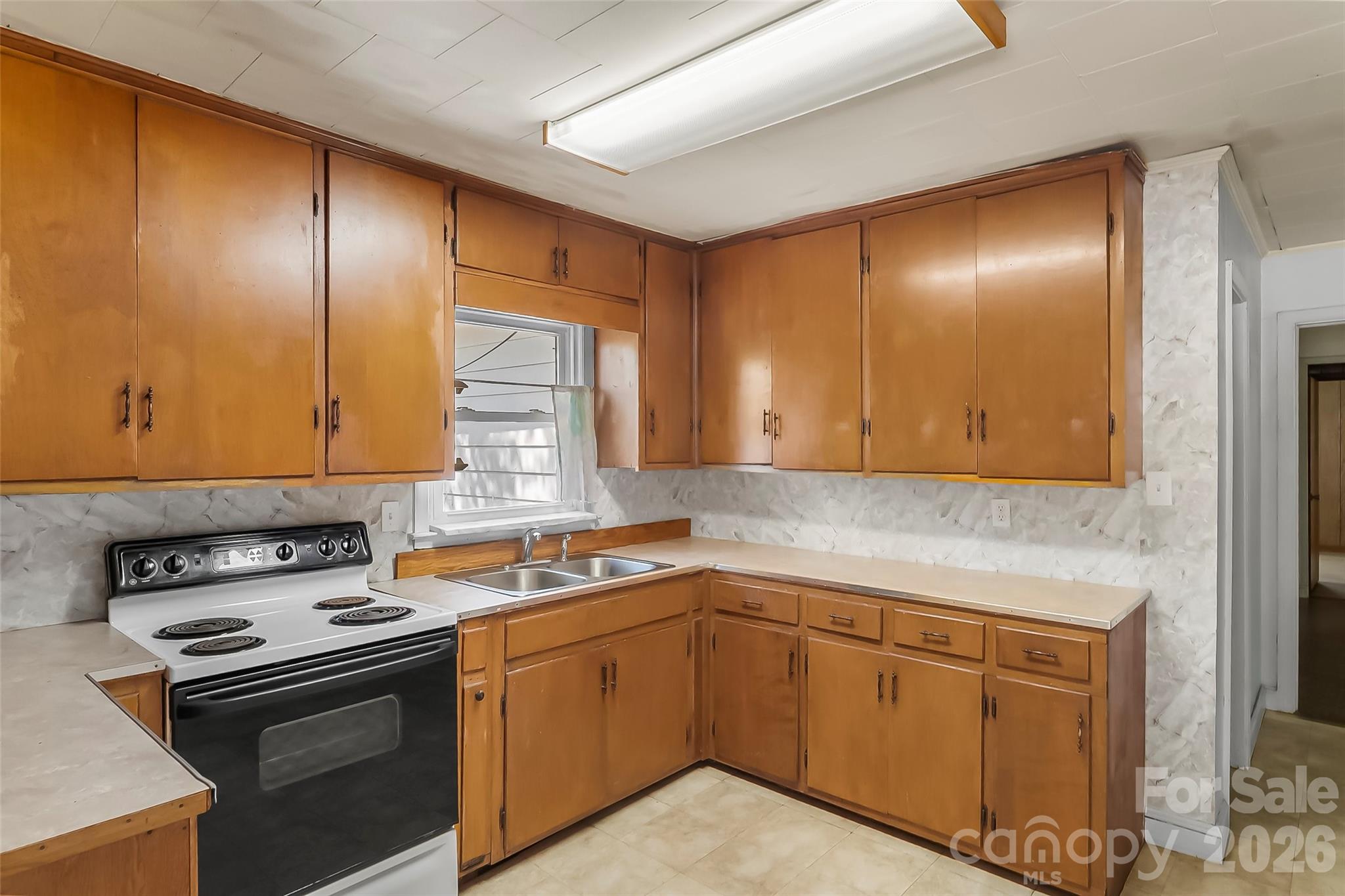 428 Melrose Street Southwest Lenoir, NC 28645 - Photo 11 of 34 a kitchen with a sink stove and cabinets