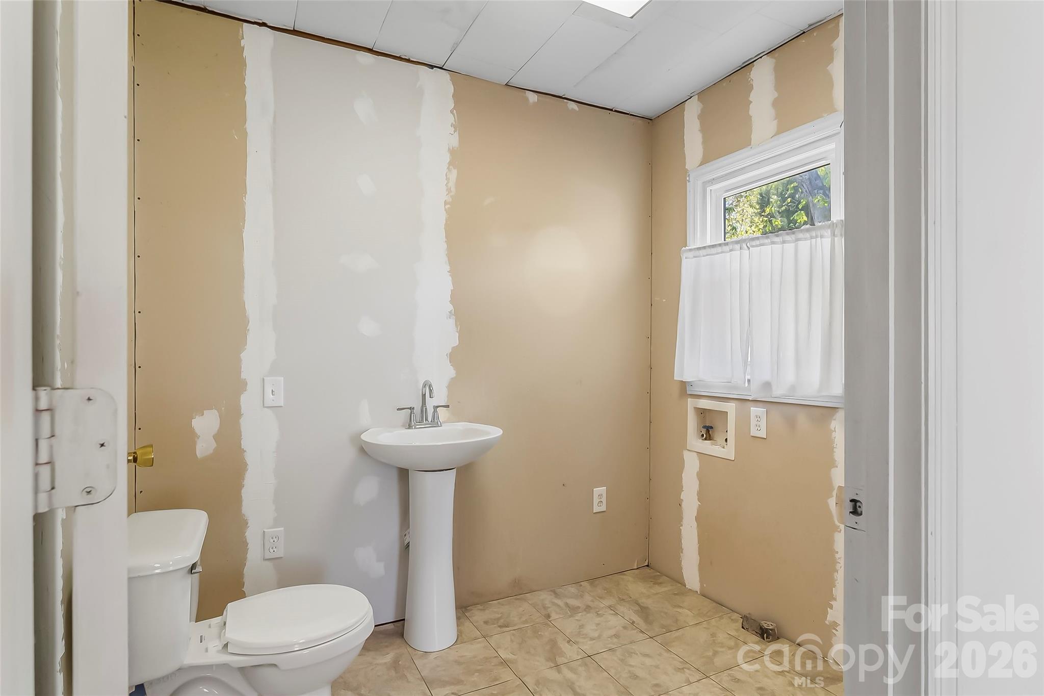 428 Melrose Street Southwest Lenoir, NC 28645 - Photo 19 of 34 a bathroom with a sink a toilet and shower