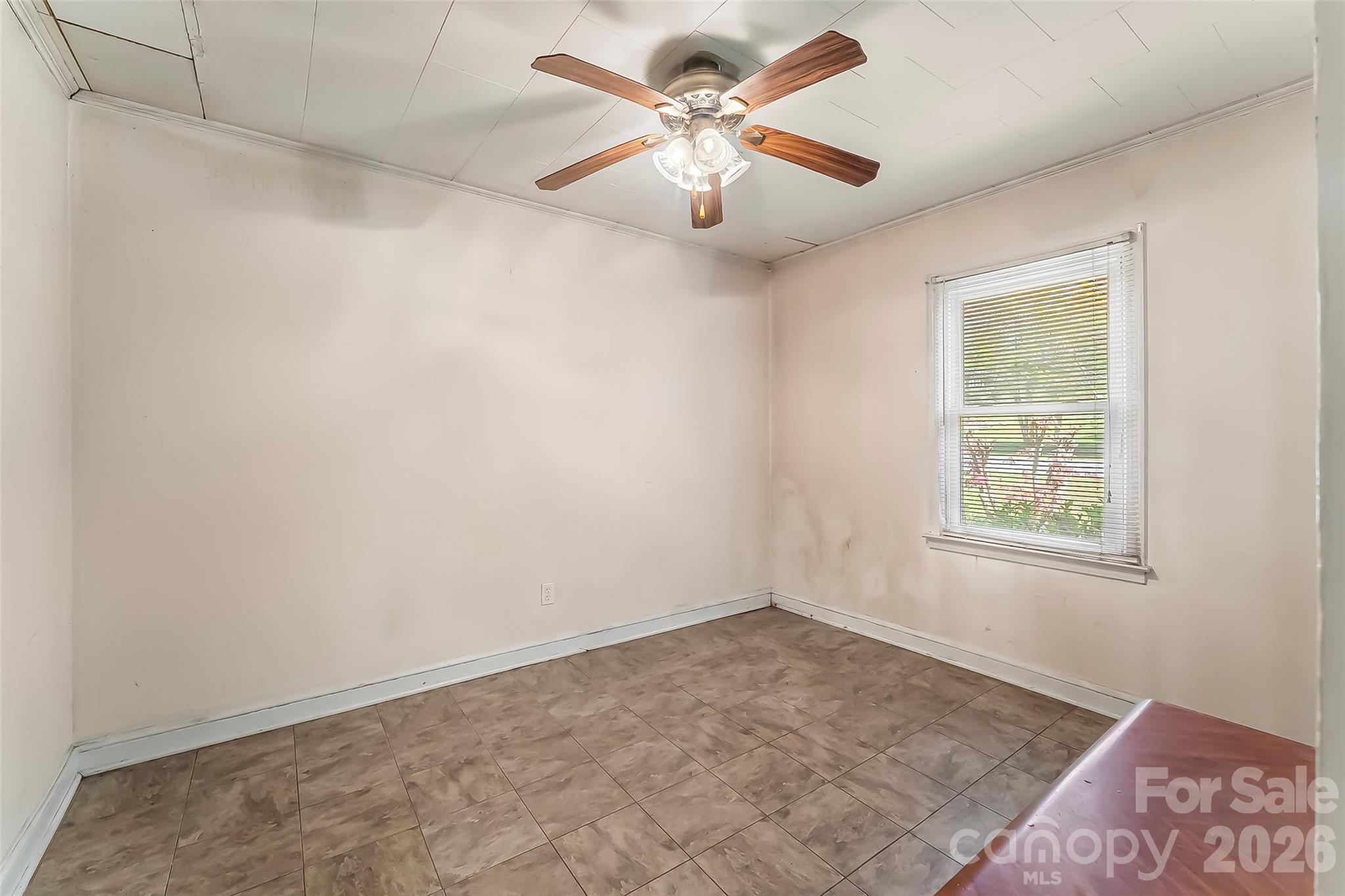 428 Melrose Street Southwest Lenoir, NC 28645 - Photo 21 of 34 an empty room with a window and a fan