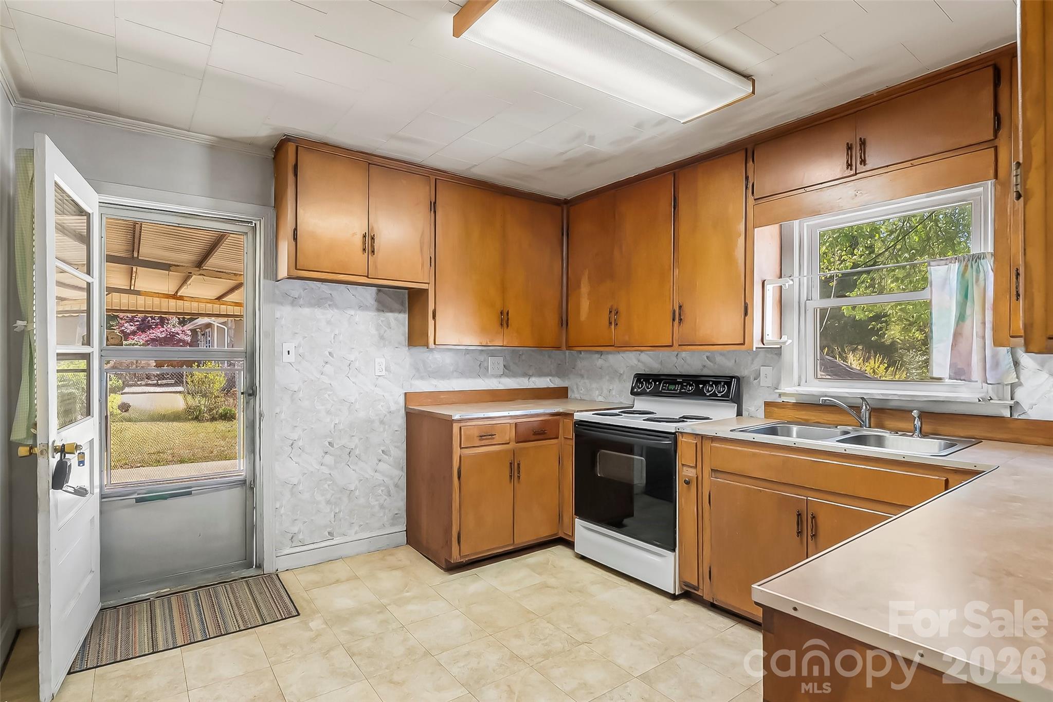 428 Melrose Street Southwest Lenoir, NC 28645 - Photo 10 of 34 a kitchen with stainless steel appliances granite countertop a sink stove and refrigerator